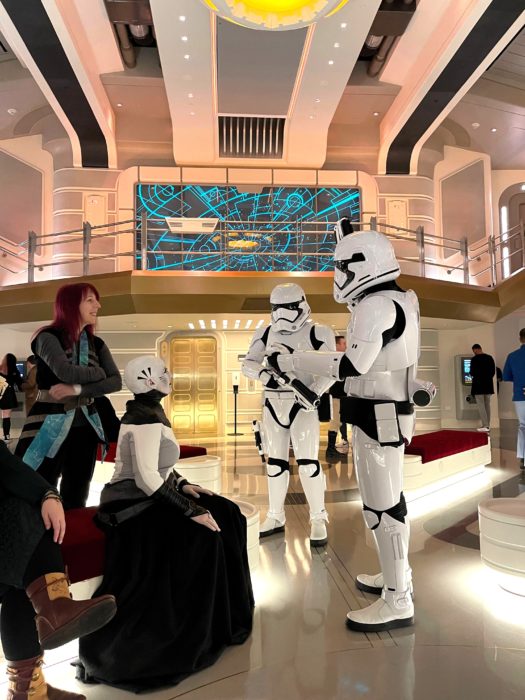 Stormtroopers (right) talk to guests (left) aboard the Halcyon