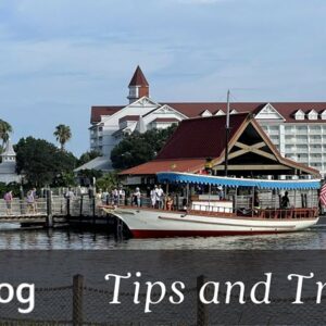 staying cool at disney world cover image showing a boat at the polynesian boat dock with grand floridian in the background