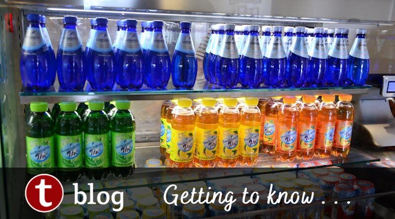 Hydration Disney World Theme Parks cover image showing a beverage case with water bottles prominently displayed on the top shelf and other drinks below.