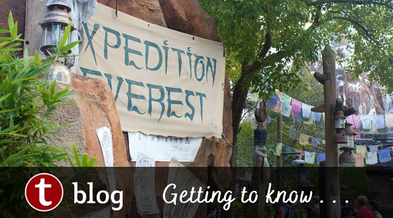 Getting to Know Expedition Everest cover image showing the sign for the ride next to a pathway overhung with flags, with the mountain visible through the trees at the back right.