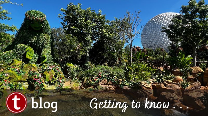 Getting to Know Journey of Water cover image with a wide shot showing Te Fiti on the left behind a large natural-looking pool of water with the EPCOT ball in the back right